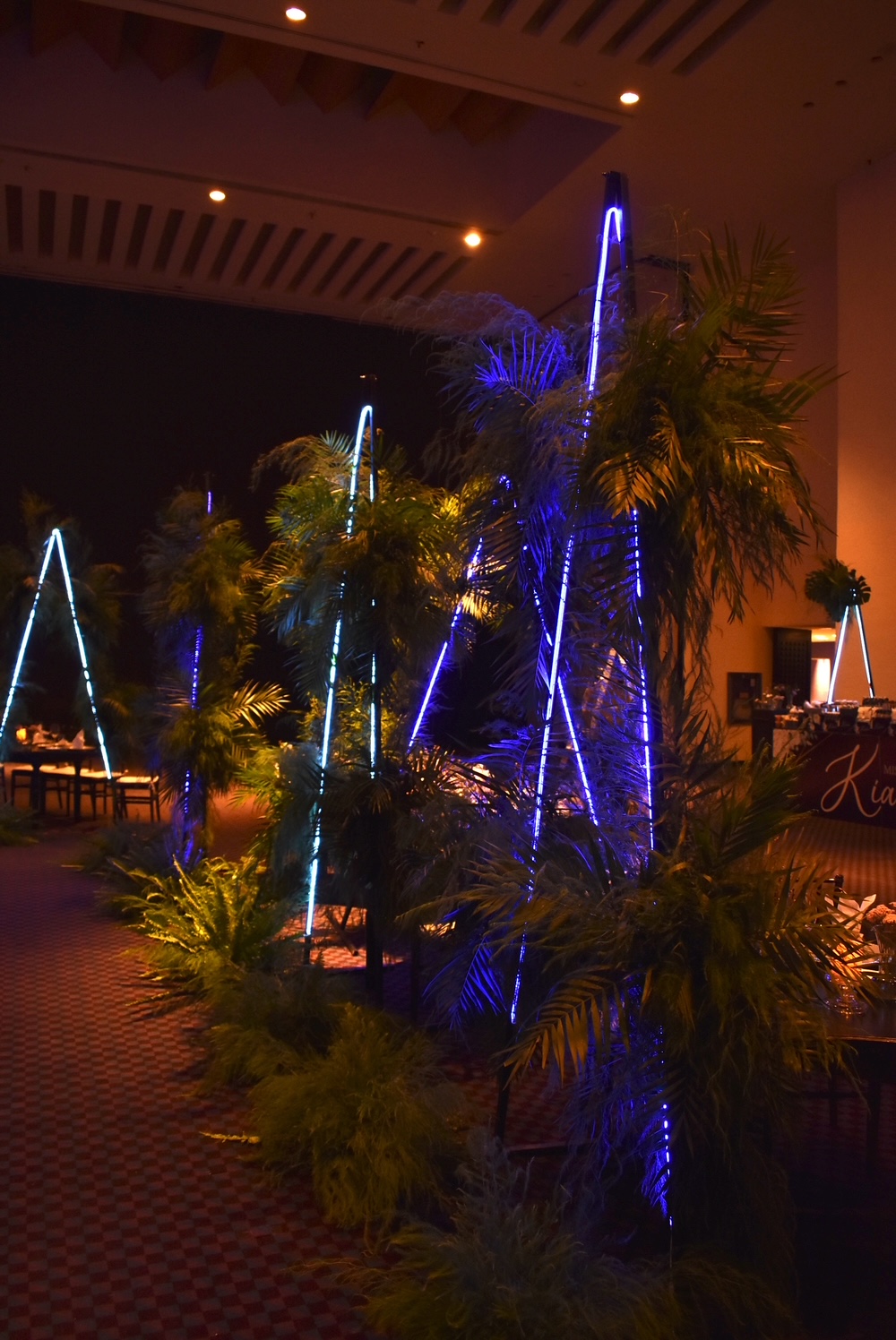 Desk with leather desk pad, walnut desk organizer, wireless keyboard and mouse, and porcelain mug.