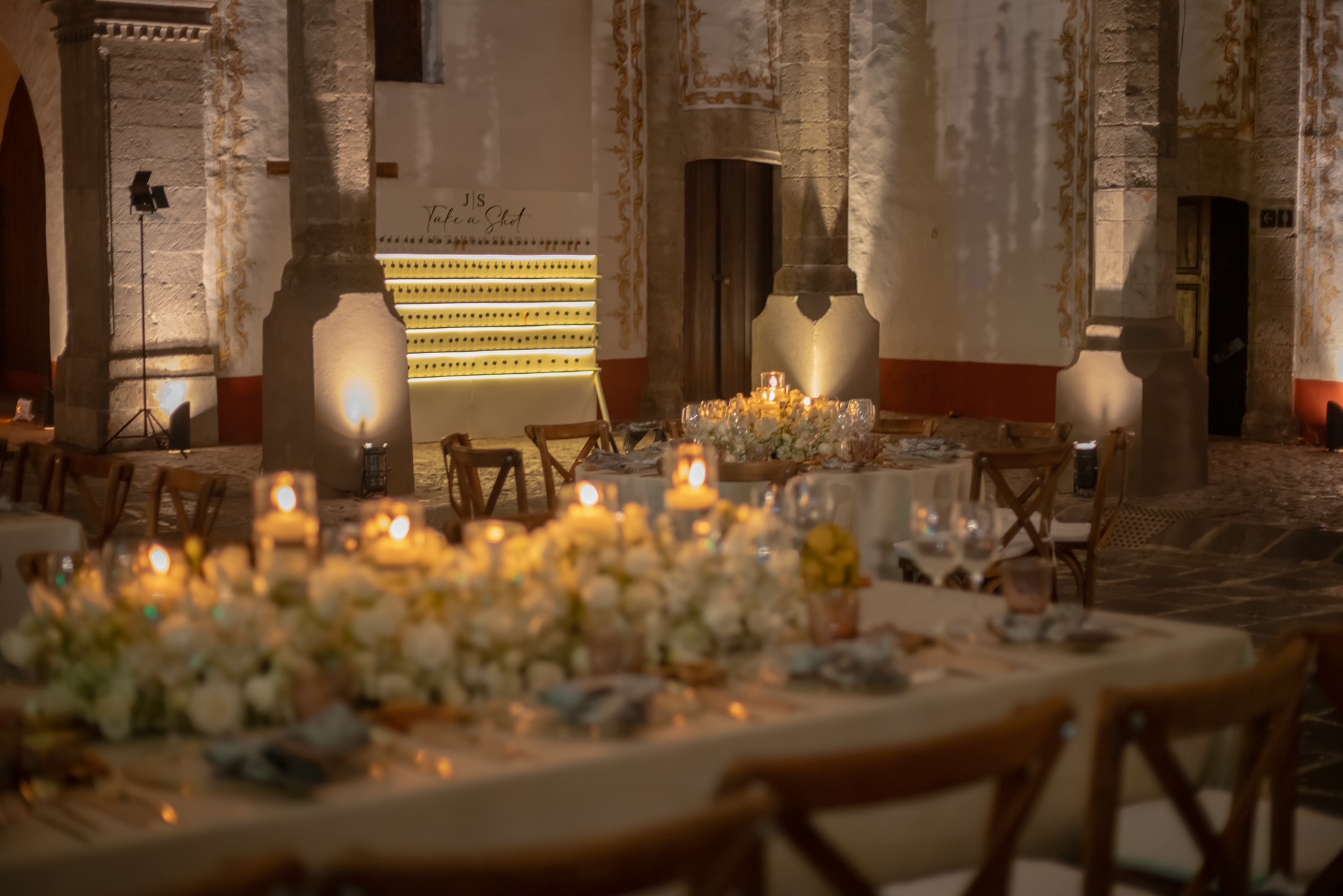 Desk with leather desk pad, walnut desk organizer, wireless keyboard and mouse, and porcelain mug.