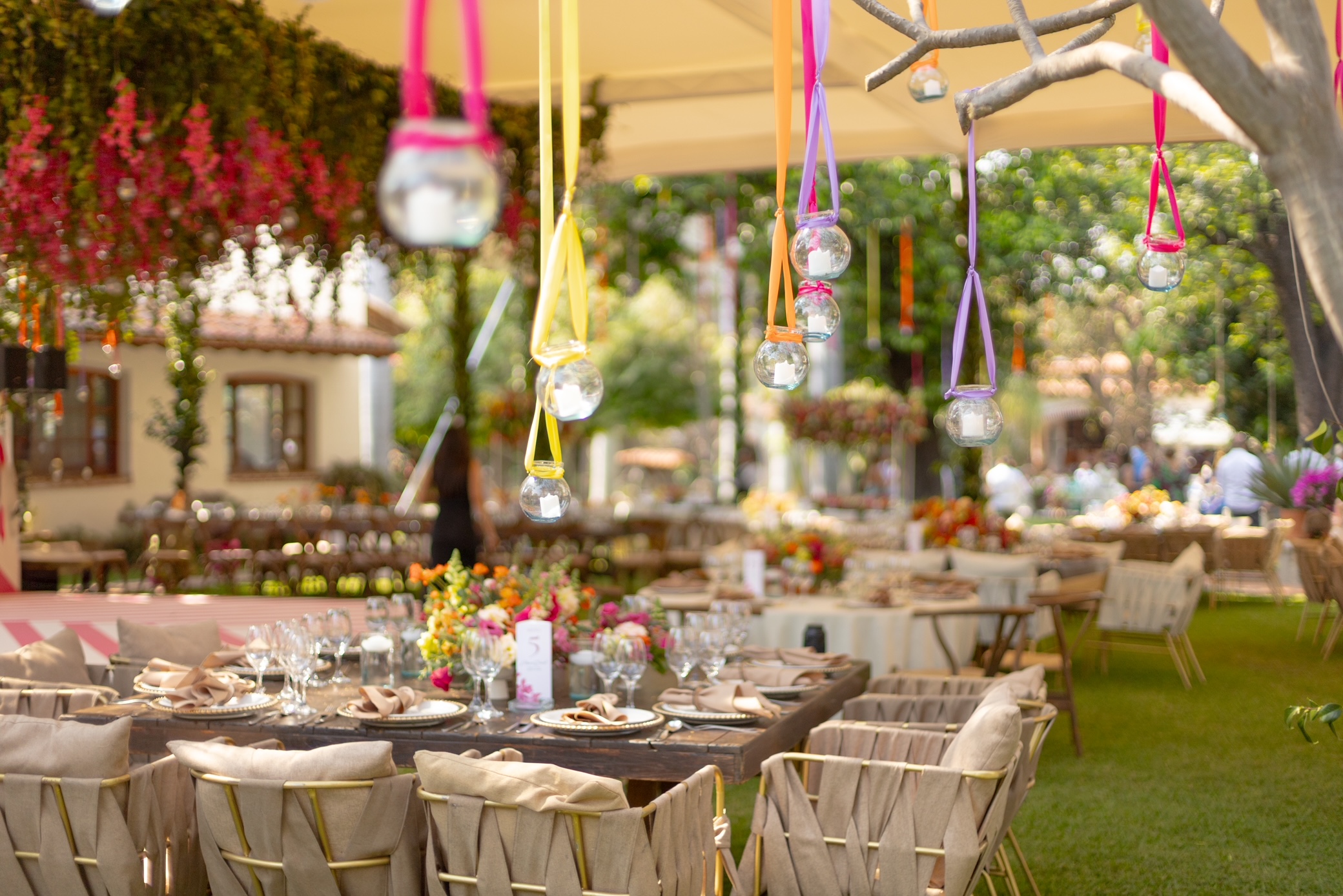 Desk with leather desk pad, walnut desk organizer, wireless keyboard and mouse, and porcelain mug.