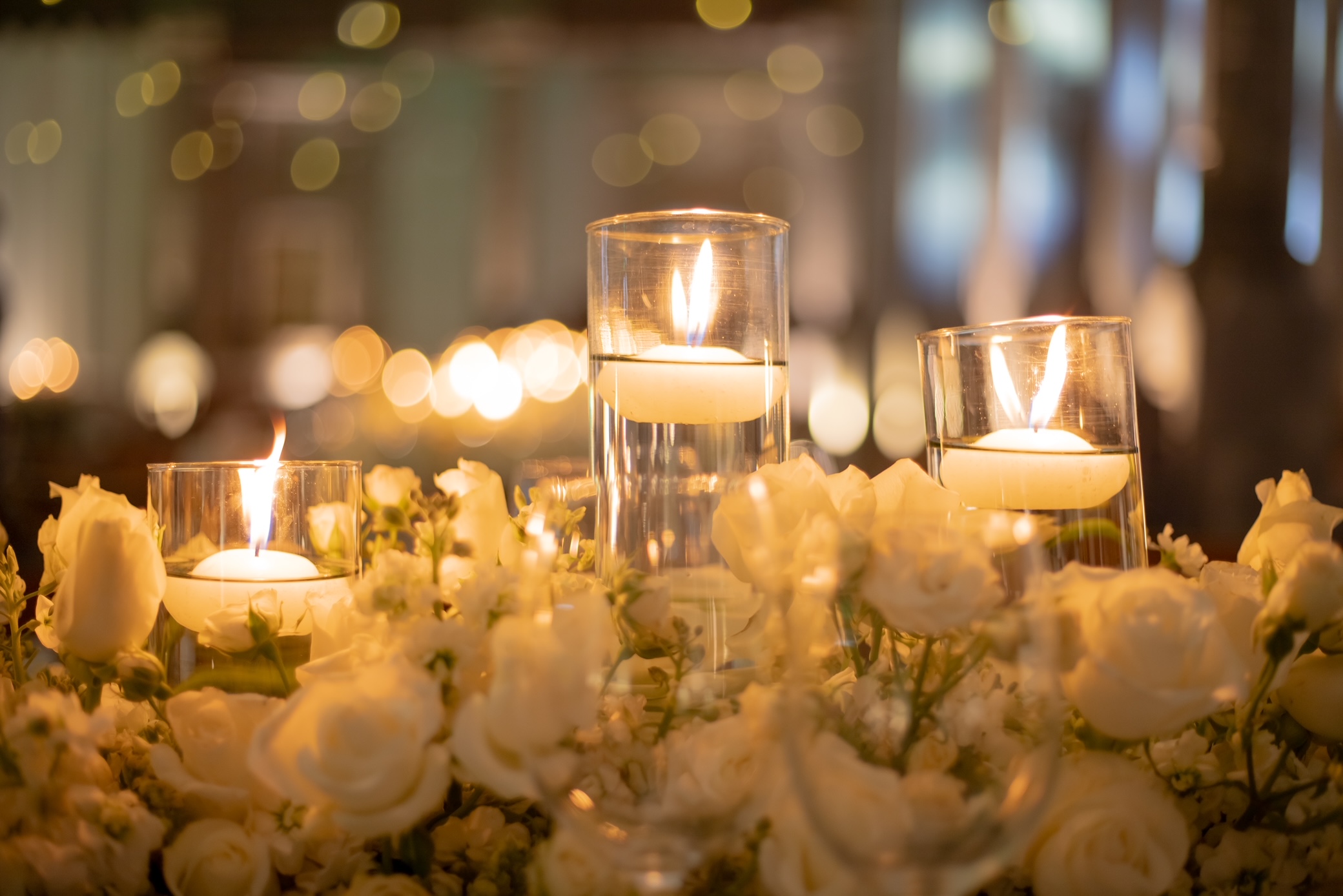 Desk with leather desk pad, walnut desk organizer, wireless keyboard and mouse, and porcelain mug.