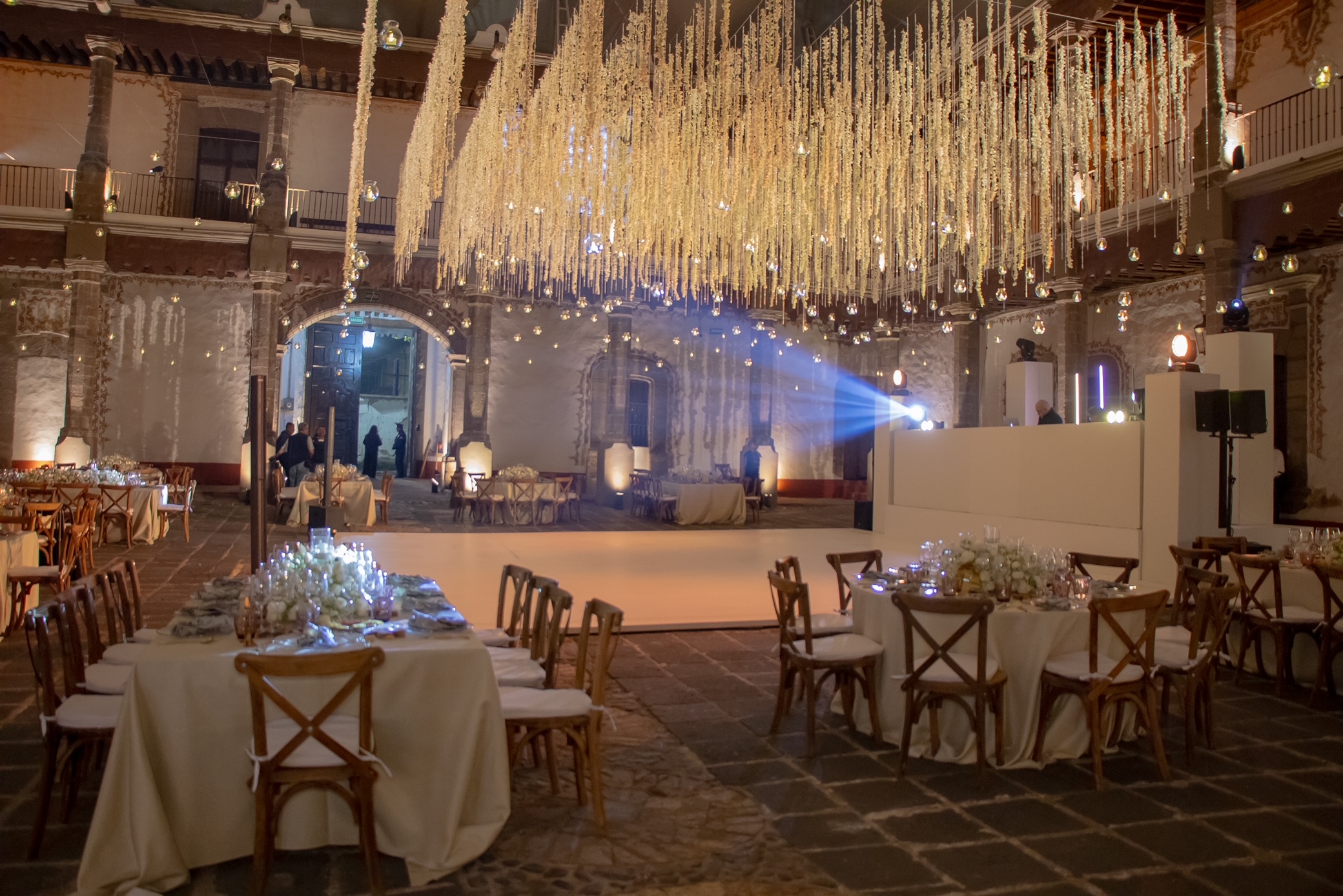 Desk with leather desk pad, walnut desk organizer, wireless keyboard and mouse, and porcelain mug.