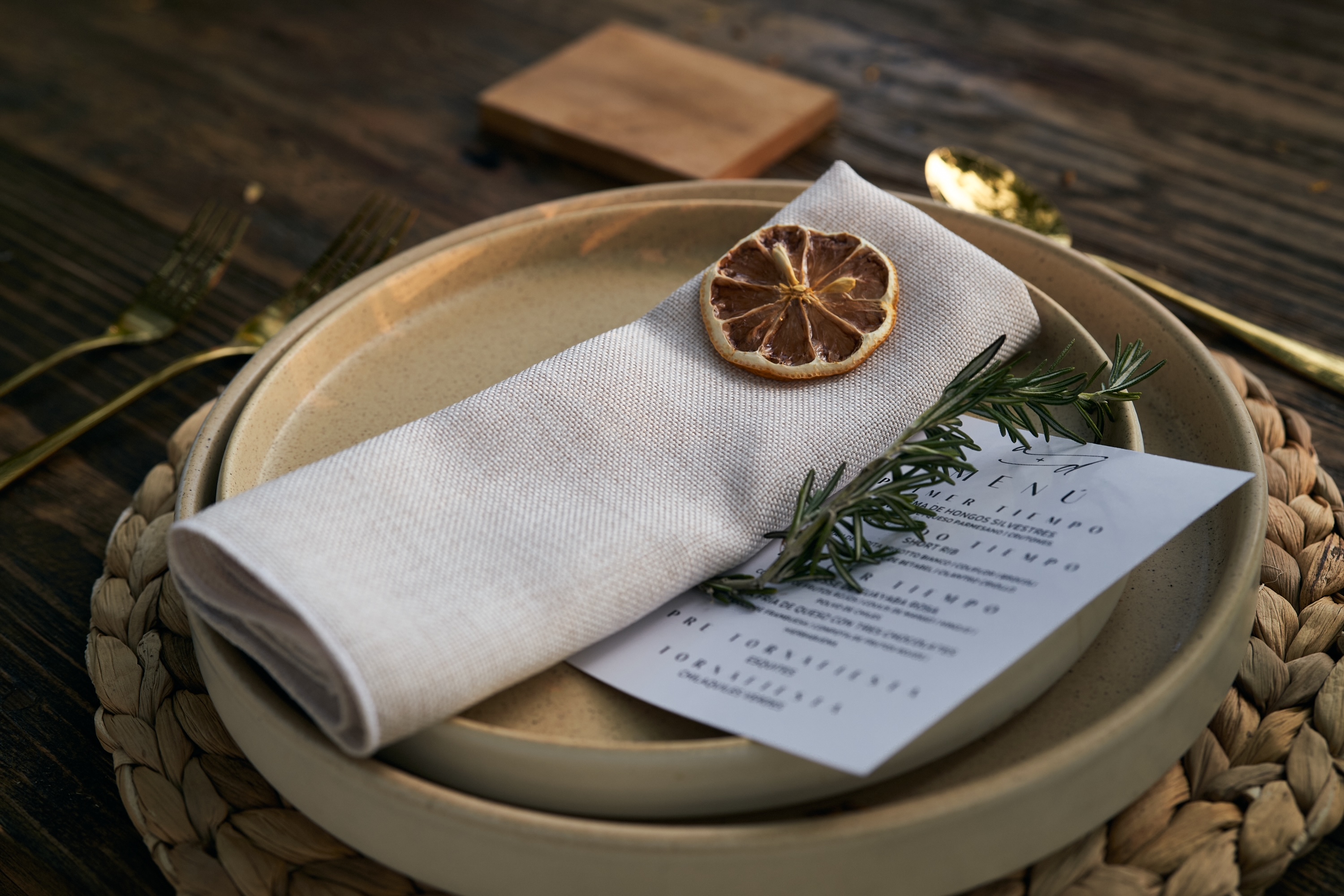 Desk with leather desk pad, walnut desk organizer, wireless keyboard and mouse, and porcelain mug.