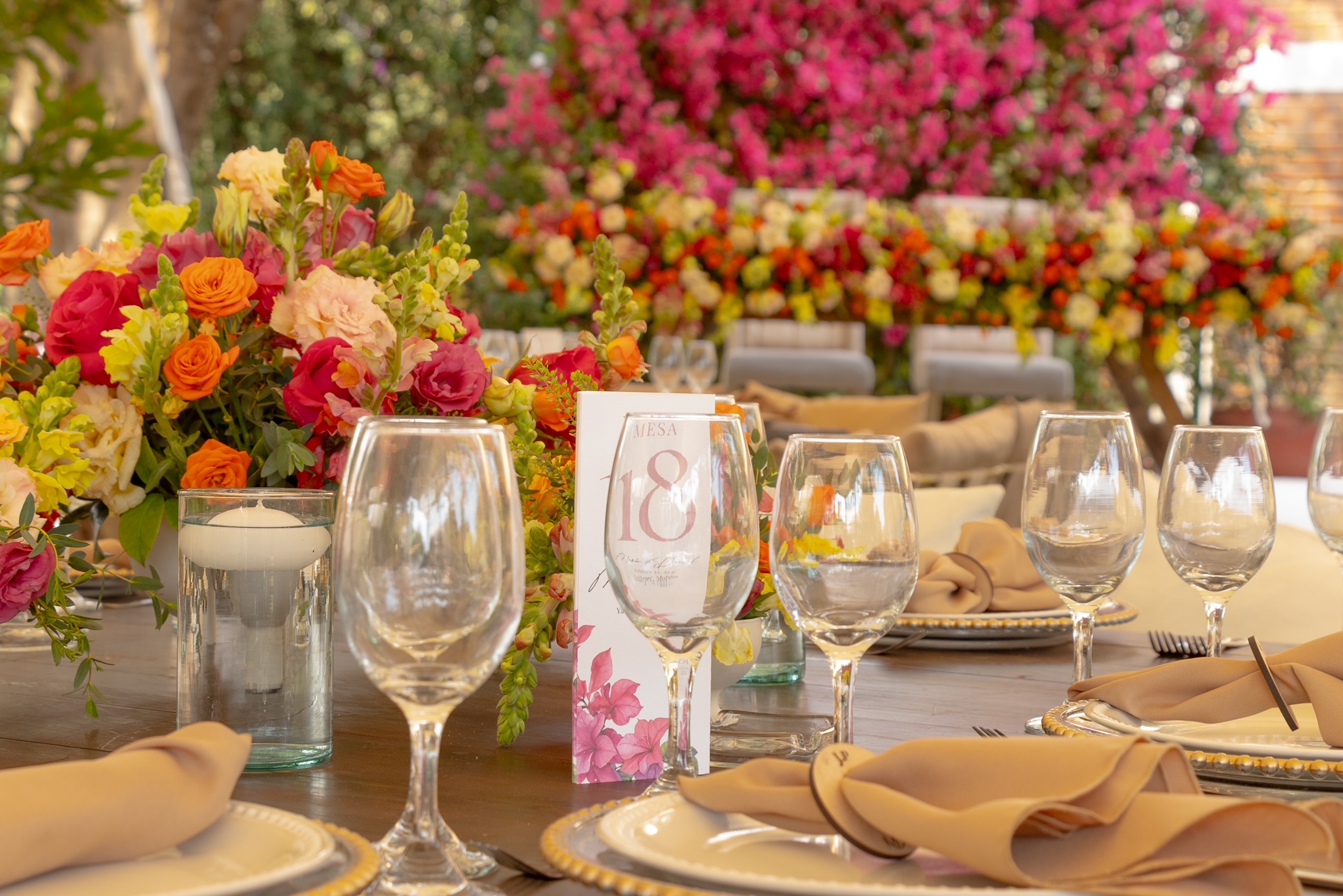 Desk with leather desk pad, walnut desk organizer, wireless keyboard and mouse, and porcelain mug.