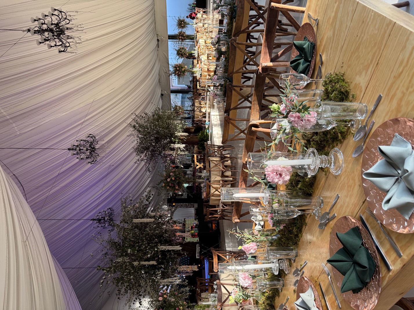 Desk with leather desk pad, walnut desk organizer, wireless keyboard and mouse, and porcelain mug.