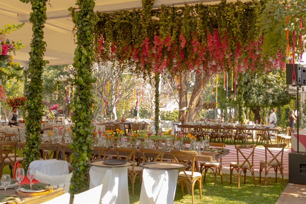 Desk with leather desk pad, walnut desk organizer, wireless keyboard and mouse, and porcelain mug.