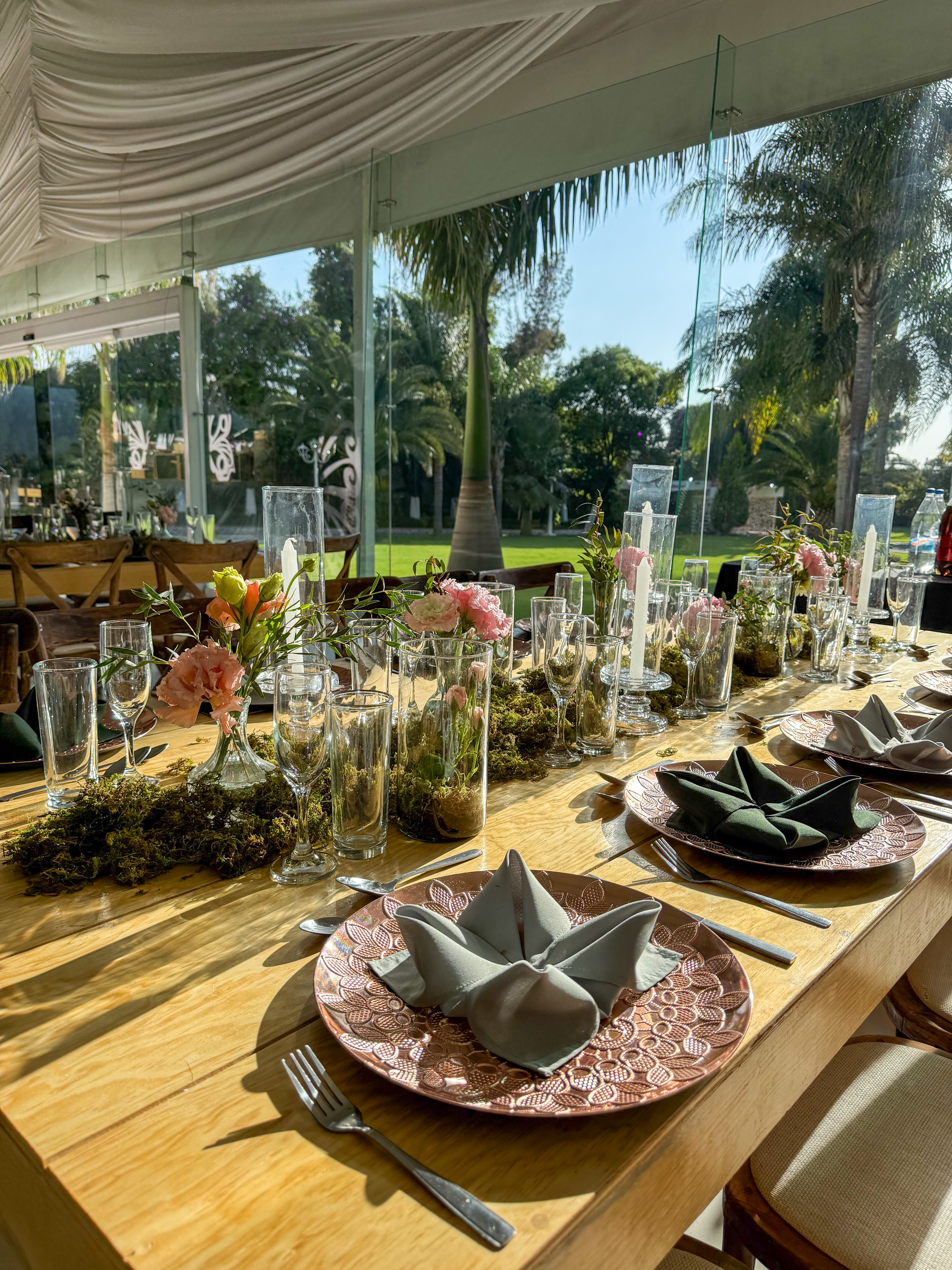 Desk with leather desk pad, walnut desk organizer, wireless keyboard and mouse, and porcelain mug.