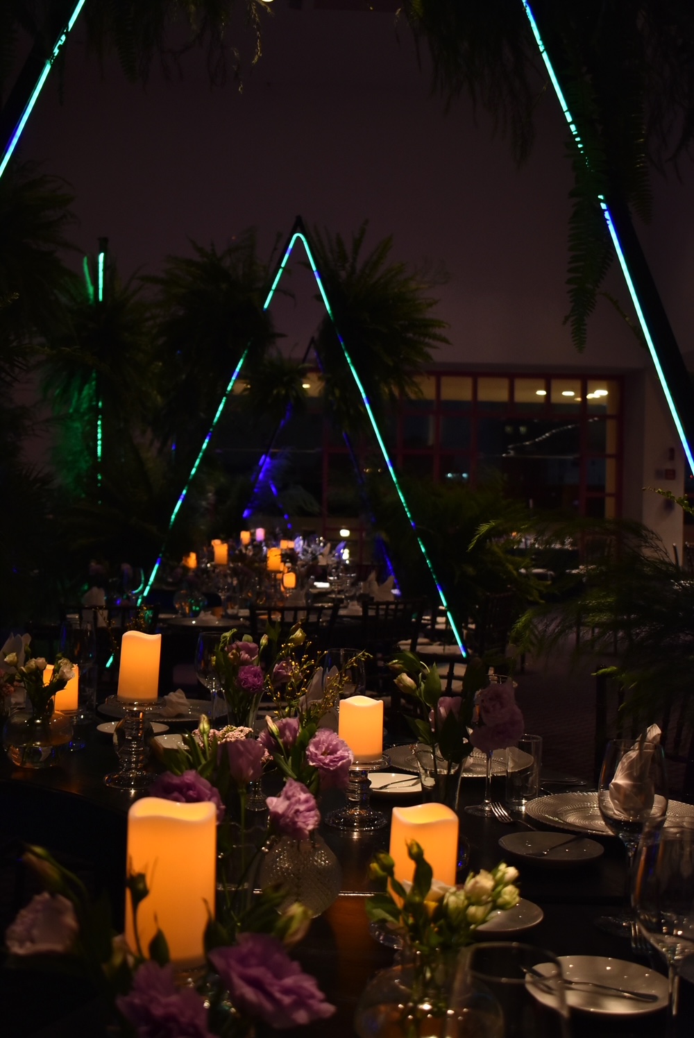 Desk with leather desk pad, walnut desk organizer, wireless keyboard and mouse, and porcelain mug.