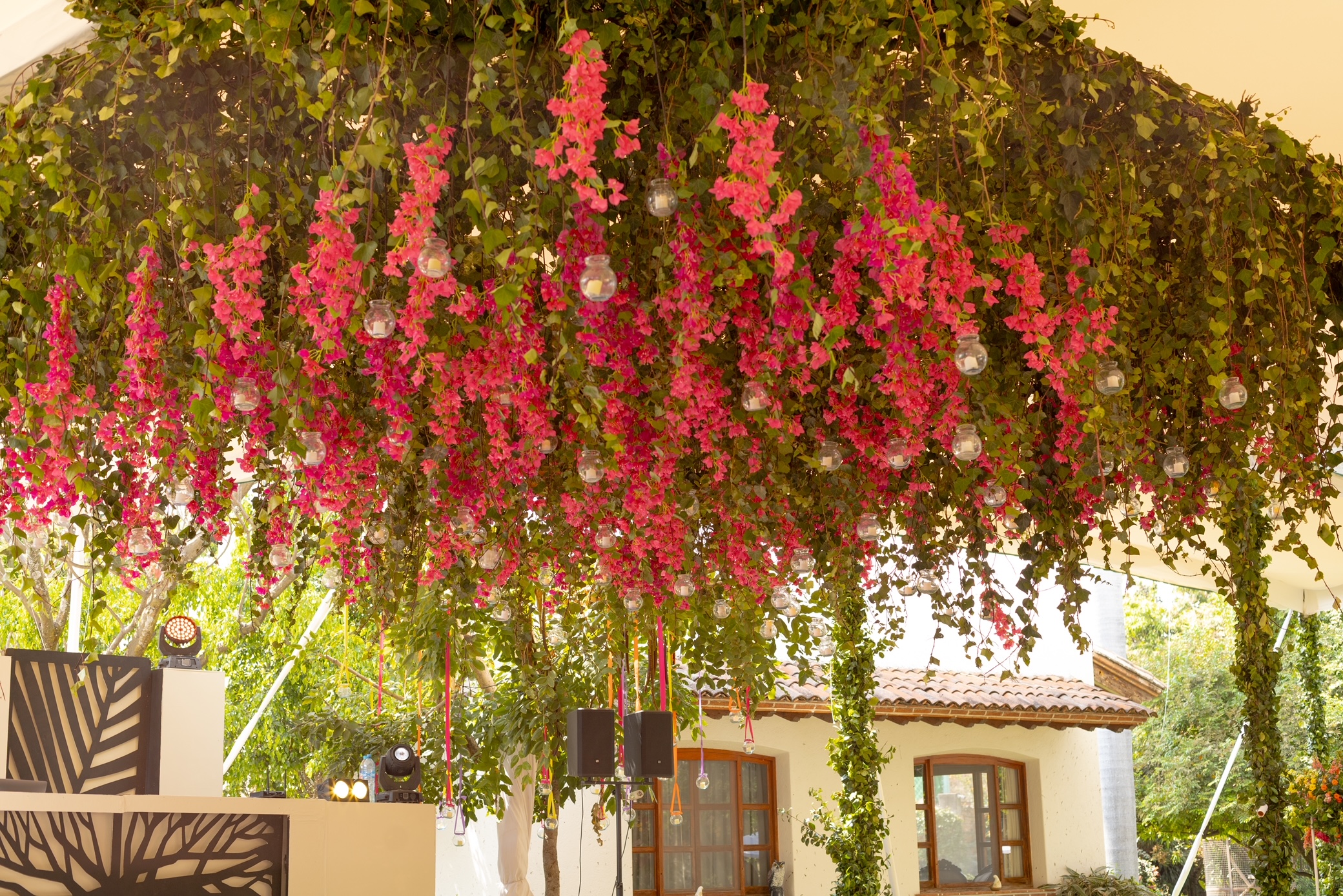 Desk with leather desk pad, walnut desk organizer, wireless keyboard and mouse, and porcelain mug.