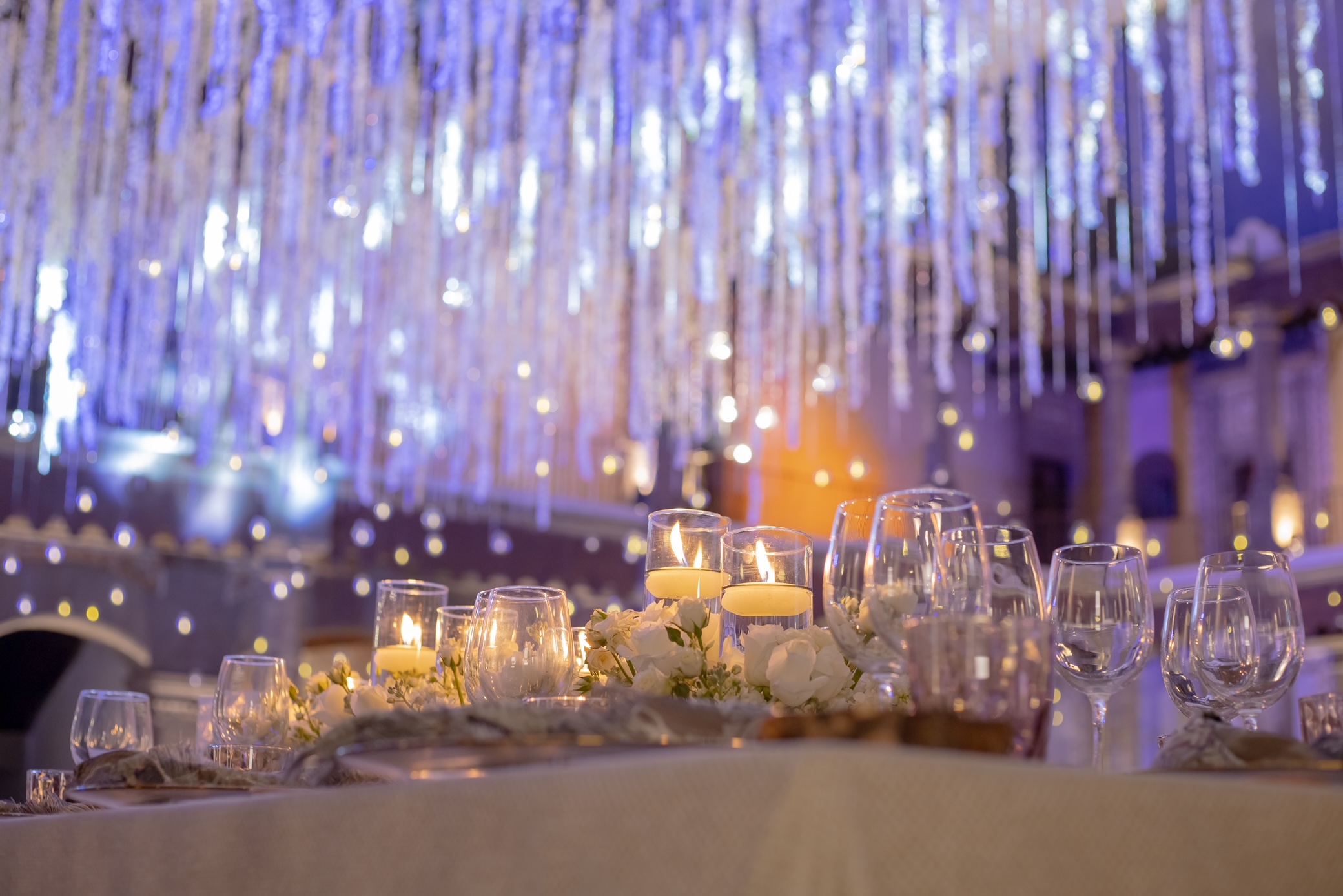 Desk with leather desk pad, walnut desk organizer, wireless keyboard and mouse, and porcelain mug.