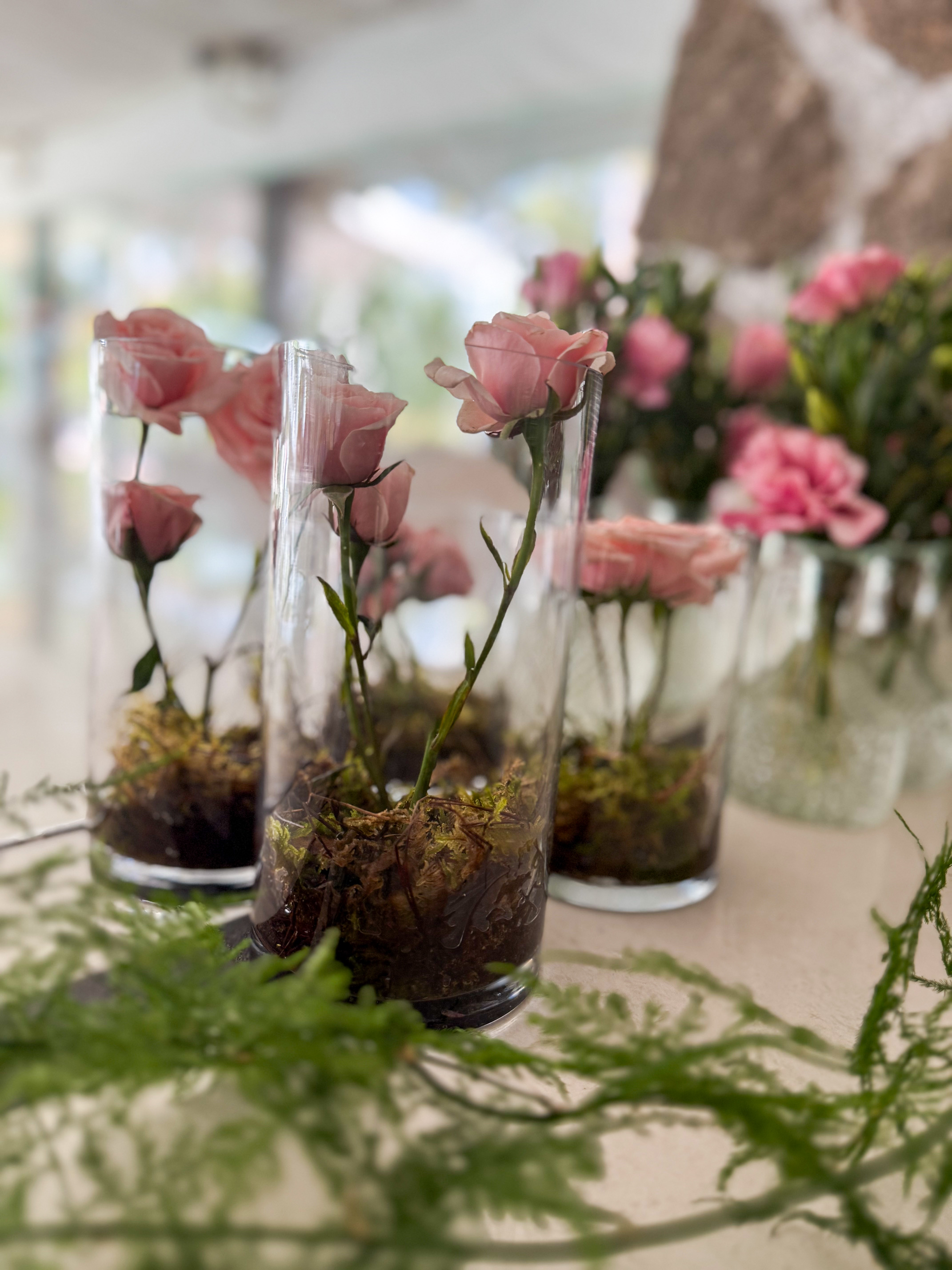 Desk with leather desk pad, walnut desk organizer, wireless keyboard and mouse, and porcelain mug.