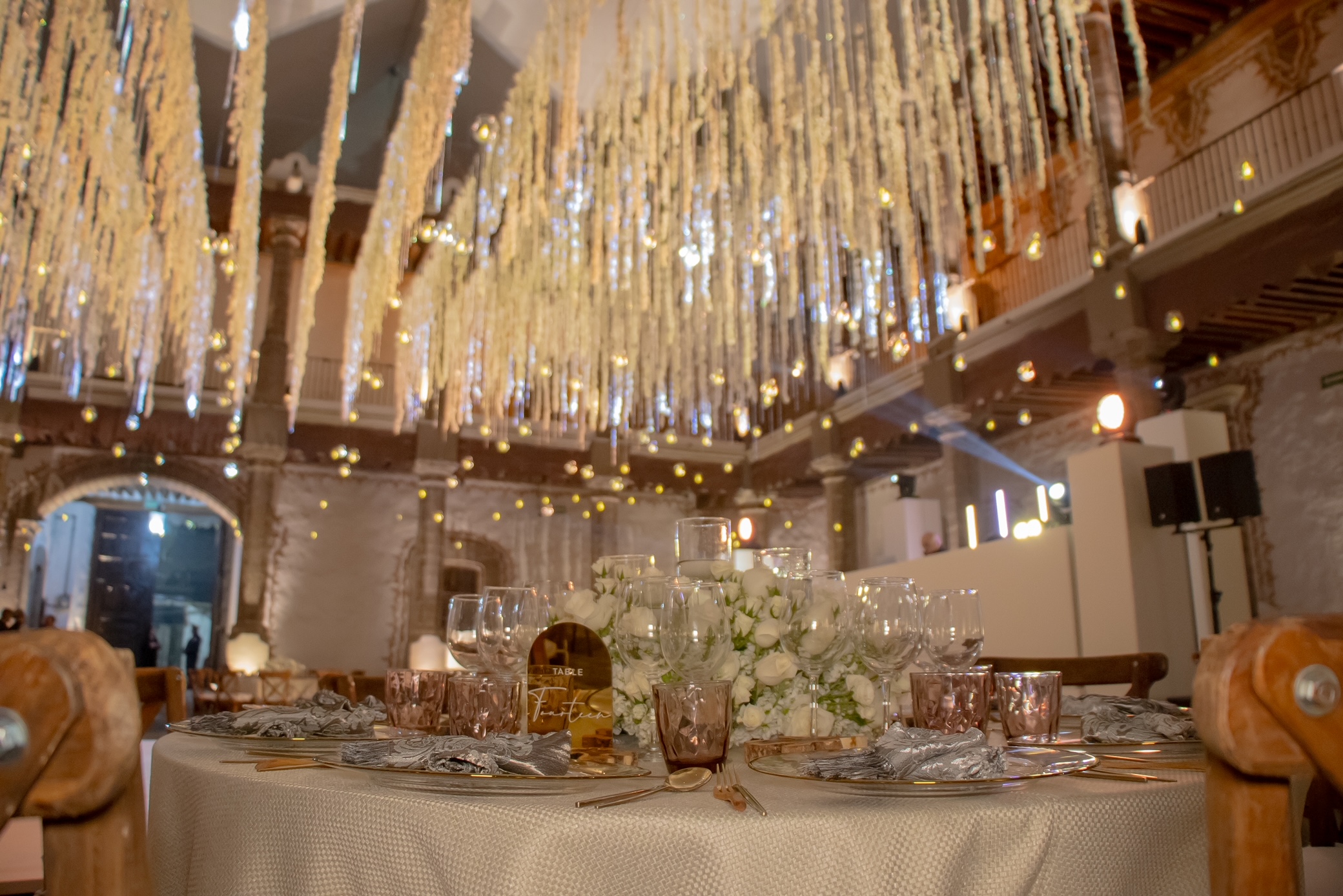 Desk with leather desk pad, walnut desk organizer, wireless keyboard and mouse, and porcelain mug.