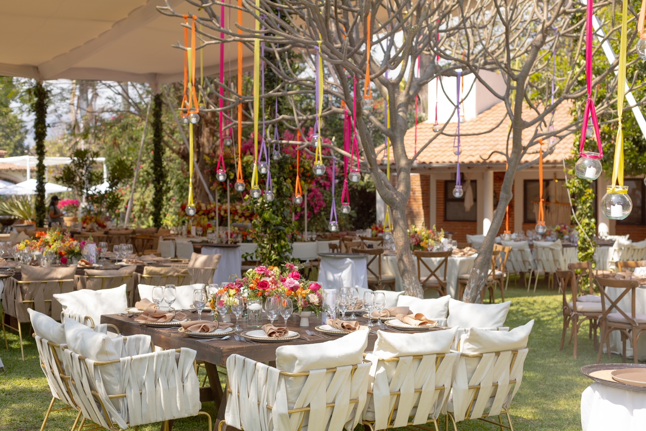 Desk with leather desk pad, walnut desk organizer, wireless keyboard and mouse, and porcelain mug.