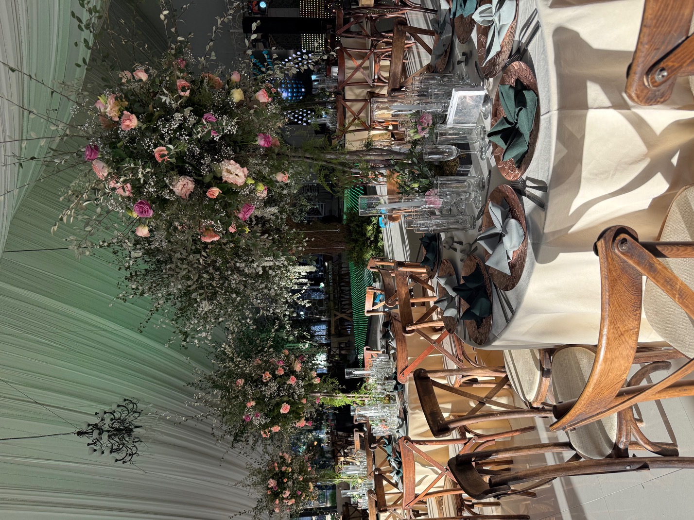 Desk with leather desk pad, walnut desk organizer, wireless keyboard and mouse, and porcelain mug.