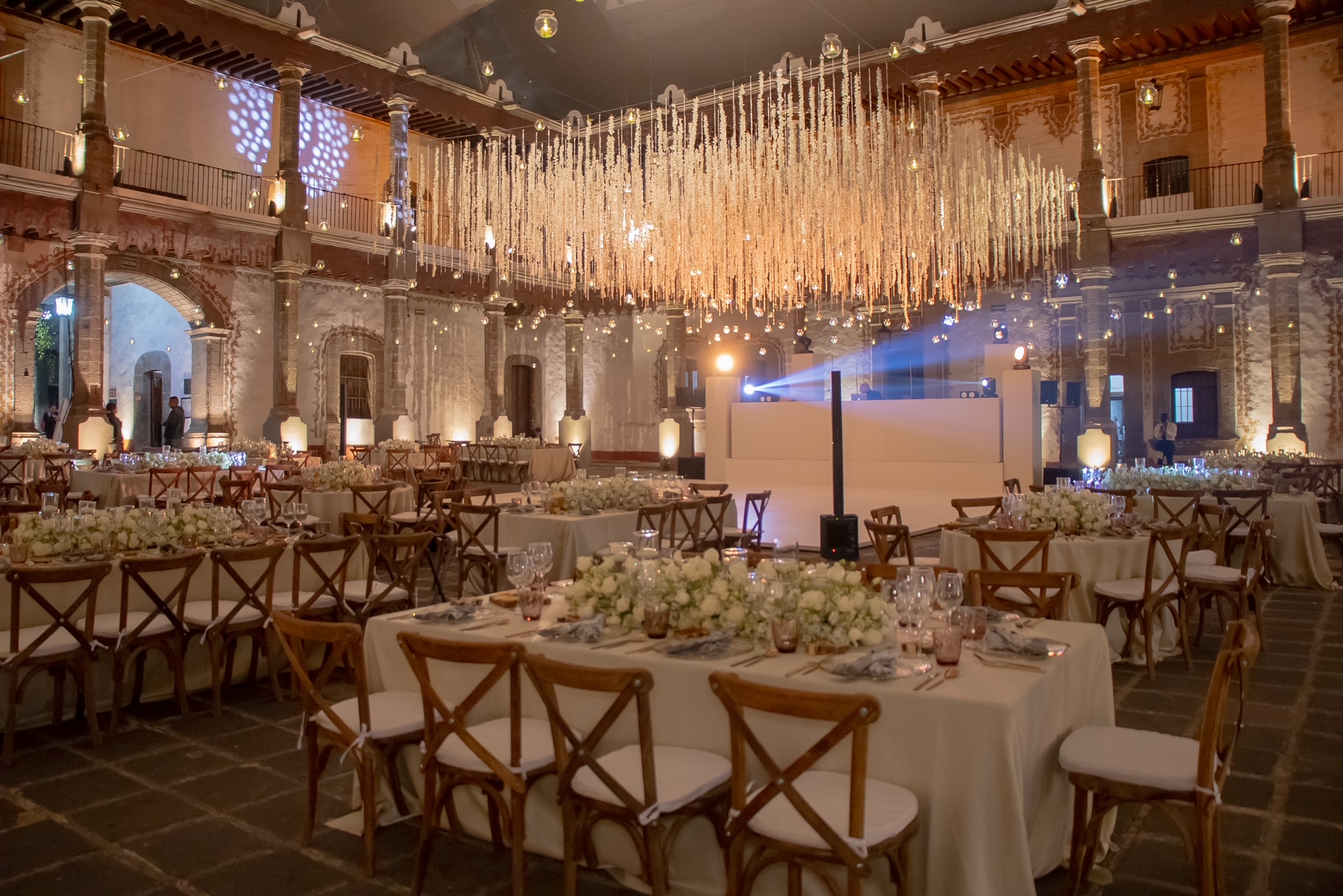 Desk with leather desk pad, walnut desk organizer, wireless keyboard and mouse, and porcelain mug.