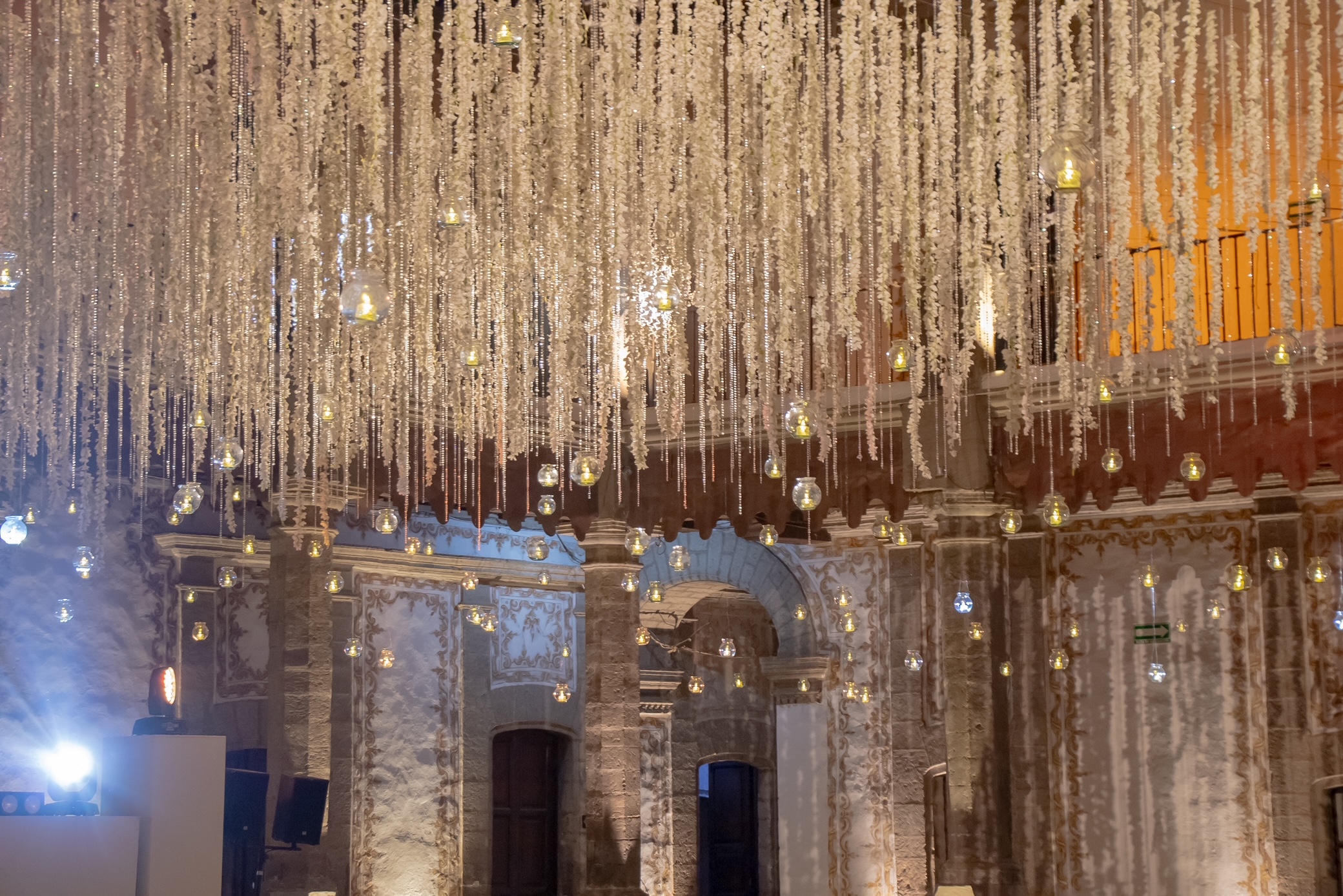 Desk with leather desk pad, walnut desk organizer, wireless keyboard and mouse, and porcelain mug.