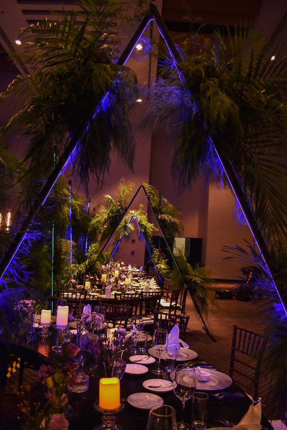 Desk with leather desk pad, walnut desk organizer, wireless keyboard and mouse, and porcelain mug.