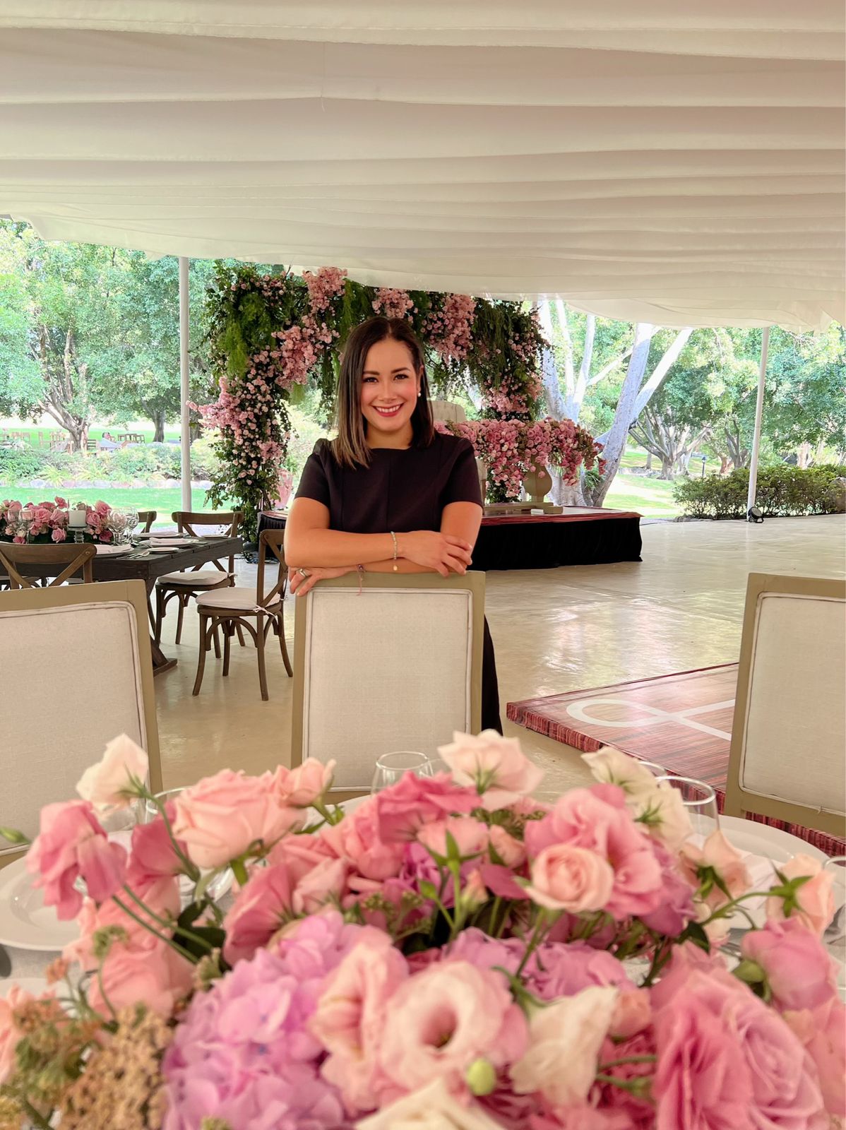 Desk with leather desk pad, walnut desk organizer, wireless keyboard and mouse, and porcelain mug.
