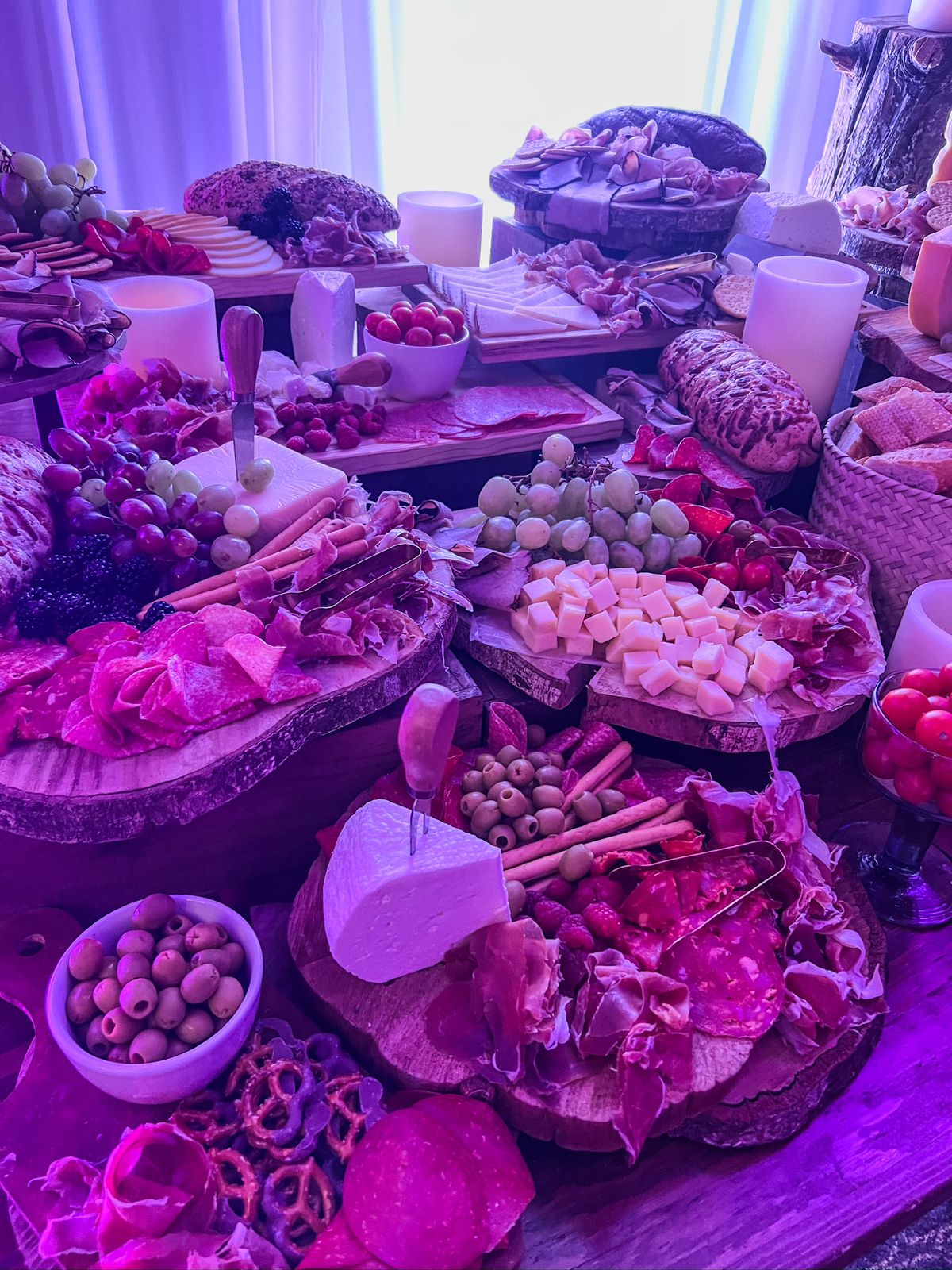 Desk with leather desk pad, walnut desk organizer, wireless keyboard and mouse, and porcelain mug.